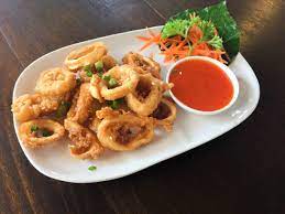 Calamari stir fried with onions, bell peppers, garlic and cilantro